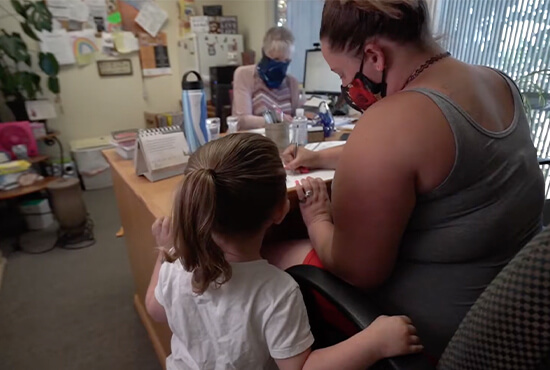 A woman and her child applying for supportive services.